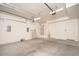 Spacious two car garage with storage racks, water heater and door to exterior at 2406 N 142Nd Ave, Goodyear, AZ 85395