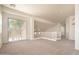 Spacious and bright living room with carpet flooring, white railing, and large windows, creating an inviting atmosphere at 2406 N 142Nd Ave, Goodyear, AZ 85395
