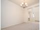 Bright and airy living room featuring neutral walls, plush carpet, and an elegant chandelier at 2406 N 142Nd Ave, Goodyear, AZ 85395