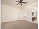 Spacious main bedroom with neutral carpet, ceiling fan, and attached bathroom for ultimate comfort at 2406 N 142Nd Ave, Goodyear, AZ 85395