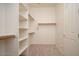 Well-organized walk-in closet with built-in shelving and ample storage space for clothing and accessories at 2406 N 142Nd Ave, Goodyear, AZ 85395