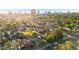 Aerial view of a neighborhood with lush trees and landscaping, with a cityscape visible in the background at 2534 N 10Th St, Phoenix, AZ 85006