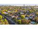 Aerial view showcases neighborhood homes with mature trees, nearby streets, and cityscape at 2534 N 10Th St, Phoenix, AZ 85006