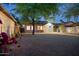 Backyard featuring a mature tree, gravel landscaping, and brick home with a small storage shed at 2534 N 10Th St, Phoenix, AZ 85006