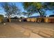 Spacious backyard featuring gravel landscaping, stepping stones, a block wall, and mature trees at 2534 N 10Th St, Phoenix, AZ 85006