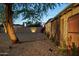 Private backyard showcasing gravel landscaping, trees, flowers, and a wooden fence at 2534 N 10Th St, Phoenix, AZ 85006