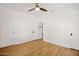 Bedroom featuring hardwood floors, white walls, ceiling fan and doors to other rooms in the home at 2534 N 10Th St, Phoenix, AZ 85006