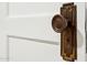 Close-up of an antique bronze doorknob on a white door, showcasing historic charm at 2534 N 10Th St, Phoenix, AZ 85006
