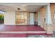 Covered front porch with red painted concrete slab, bench seating, and brick supports on well maintained brick home at 2534 N 10Th St, Phoenix, AZ 85006