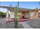 Inviting covered front porch featuring a bench, brick accents, and desert landscaping at 2534 N 10Th St, Phoenix, AZ 85006