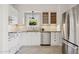 Updated kitchen with white cabinetry, stainless steel appliances, and tile backsplash at 2534 N 10Th St, Phoenix, AZ 85006