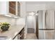 Well-lit kitchen features stainless steel appliances, ample counter space, and glass-front cabinets at 2534 N 10Th St, Phoenix, AZ 85006