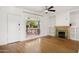 Bright living room with hardwood floors, fireplace, and a view to the charming front porch bench at 2534 N 10Th St, Phoenix, AZ 85006