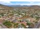 This aerial shows many houses in the neighborhood with nearby mountains in the background at 3019 W Trail Dr, Phoenix, AZ 85086