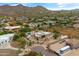 An aerial view of a desert home showcases the surrounding mountains and a private pool at 3019 W Trail Dr, Phoenix, AZ 85086