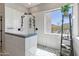 Bright bathroom showcasing double shower heads, tiled walls, and a window overlooking the natural landscape at 3019 W Trail Dr, Phoenix, AZ 85086