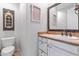 Charming bathroom with a distressed vanity, farmhouse-style decor, tile floors and large mirror above the sink at 3019 W Trail Dr, Phoenix, AZ 85086