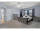 Bedroom featuring soft carpet, a decorative bedframe, and ample natural light at 3019 W Trail Dr, Phoenix, AZ 85086