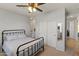 Bedroom featuring a ceiling fan, closet with mirrored door, carpeted floor and light blue bedding and metal frame bed at 3019 W Trail Dr, Phoenix, AZ 85086