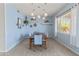 Bright dining room with a wooden table, six chairs, and stylish lighting at 3019 W Trail Dr, Phoenix, AZ 85086