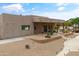 This desert property features a covered patio, rock landscaping, and walkway lighting at 3019 W Trail Dr, Phoenix, AZ 85086