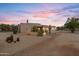This desert property features a flagpole, native landscaping, and an outdoor dining set at 3019 W Trail Dr, Phoenix, AZ 85086