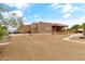 Rear exterior of the home with desert landscaping and covered patio area at 3019 W Trail Dr, Phoenix, AZ 85086