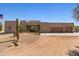 Stunning exterior of a single-story home featuring desert landscaping, an American flag and a circular driveway at 3019 W Trail Dr, Phoenix, AZ 85086