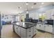 Bright kitchen with a large island, stainless steel appliances, and white cabinets at 3019 W Trail Dr, Phoenix, AZ 85086