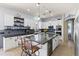Modern kitchen with white cabinets, a dark countertop island, and stainless steel appliances at 3019 W Trail Dr, Phoenix, AZ 85086