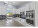 Well-equipped kitchen with stainless steel appliances, granite countertops, and white cabinets at 3019 W Trail Dr, Phoenix, AZ 85086
