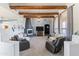 Inviting living room with exposed wood beams, a modern fireplace, neutral decor and comfortable seating at 3019 W Trail Dr, Phoenix, AZ 85086