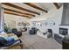 Spacious living room featuring wood beams, a fireplace, neutral decor, and comfortable leather recliners at 3019 W Trail Dr, Phoenix, AZ 85086