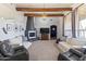 Inviting living room with exposed wood beams, a modern fireplace, neutral decor and comfortable seating at 3019 W Trail Dr, Phoenix, AZ 85086