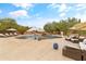 Large pool with stone waterfall feature, desert landscaping, lounge chairs, shaded areas and a basketball hoop at 3019 W Trail Dr, Phoenix, AZ 85086