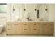 Elegant bathroom with double sinks, modern mirrors, and stylish wooden cabinetry at 3101 E Sells Dr, Phoenix, AZ 85016