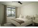 Comfortable bedroom with a plush bed, stylish linens, and natural light from the window at 3101 E Sells Dr, Phoenix, AZ 85016