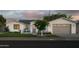 Charming exterior showcases a well-maintained lawn and a gray two-car garage with beautiful landscaping at 3101 E Sells Dr, Phoenix, AZ 85016