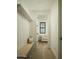 Hallway featuring a built-in bench, storage and a glimpse of a living area with natural light and hardwood flooring at 3101 E Sells Dr, Phoenix, AZ 85016