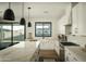 Spacious kitchen featuring white cabinets, a large island, and modern stainless steel appliances at 3101 E Sells Dr, Phoenix, AZ 85016