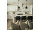 Bright kitchen featuring white cabinetry, stylish black pendant lights, and modern stainless steel appliances at 3101 E Sells Dr, Phoenix, AZ 85016