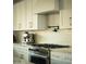 Close-up of a modern stainless steel range with white cabinetry and pot filler, showcasing a culinary haven at 3101 E Sells Dr, Phoenix, AZ 85016