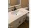 Bathroom vanity features white countertop, modern faucet, undermount sink and white cabinets at 3131 W Cochise Dr # 218, Phoenix, AZ 85051