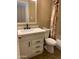 Bathroom features a vanity with storage and a shower with patterned curtain at 3131 W Cochise Dr # 218, Phoenix, AZ 85051