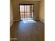 Bedroom showcasing sliding glass door leading to a balcony, with natural light enhancing the neutral color palette and modern flooring at 3131 W Cochise Dr # 218, Phoenix, AZ 85051