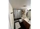 Modern bathroom features sleek black fixtures, glass-enclosed shower, and a stylish vanity with ample counter space at 3314 N 68Th St # 107, Scottsdale, AZ 85251