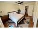 Bright bedroom with a queen bed, ceiling fan, and views into the bathroom and kitchen at 3314 N 68Th St # 107, Scottsdale, AZ 85251