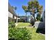 Green courtyard featuring well-maintained lawn, mature trees, shrubs, and complex buildings at 3314 N 68Th St # 107, Scottsdale, AZ 85251