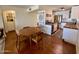 Dining area shows an open floor plan with modern appliances and a wood dining table with four chairs at 3314 N 68Th St # 107, Scottsdale, AZ 85251