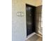 A black front door with decorative details and a unit number, ensuring easy identification for visitors at 3314 N 68Th St # 107, Scottsdale, AZ 85251